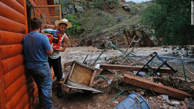 Chris Rodes helps Fred Rob salvage a friend's belongings after floods left homes and infrastructure in a shambles in Lyons, Colorado, on September 13.