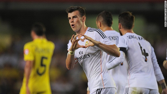 Gareth Bale's celebrates in trademark style after scoring on his Real Madrid debut against Villarreal. 