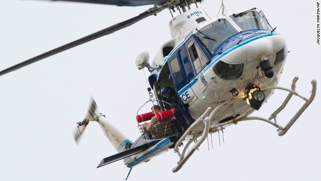 A U.S. Park Police helicopter removes a man from the Washington Navy Yard on Monday, September 16. At least 12 people were killed in a shooting rampage, according to Washington Police Chief Cathy Lanier.