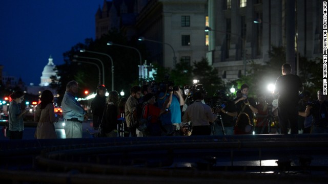 Members of the media cover the vigil Monday night.