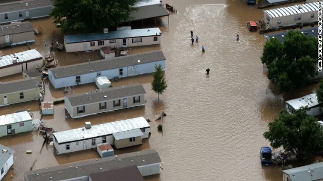 People wade through floodwater in Greeley, Colorado, on September 16.