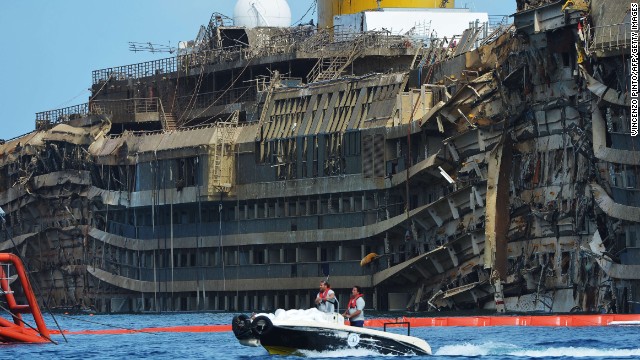 The ship had been lying on its side for 20 months off the island of Giglio. Here, members of the U.S. company Titan Salvage and the Italian marine contractor Micoperi pass by the wreckage.