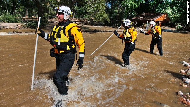 Members of the FEMA Urban Search and Rescue Nebraska Task Force 1 use probes to test for water depth while crossing floodwaters looking for missing people near Longmont, Colorado, on September 17. Stranded flood victims are being rescued by military helicopters and vehicles.