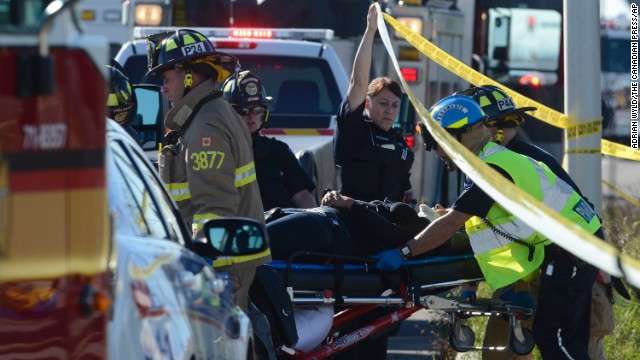 An injured passenger is taken to an ambulance on September 18.