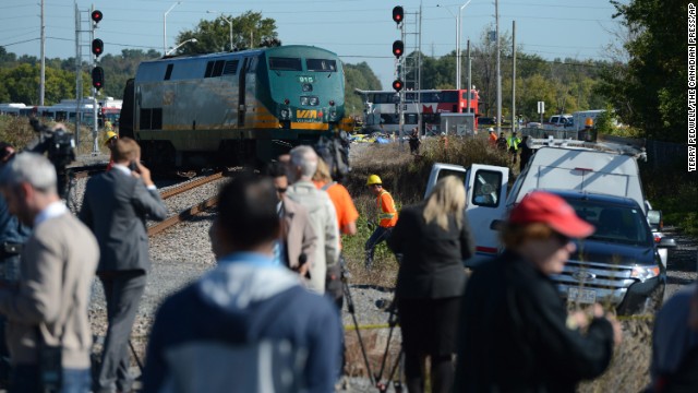 Members of the media watch as emergency crews respond to the crash on September 18.