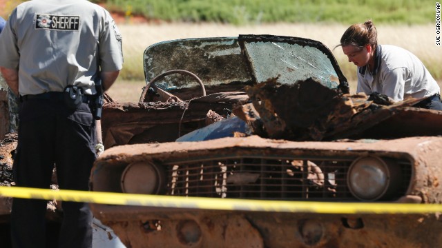 Officials examine a car at Foss Lake on September 18. 