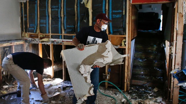 David Soleta, right, and family friend John Rice remove destroyed and contaminated walls on September 18 from Soleta's father-in-law's home, which was heavily damaged by floodwaters that swept through Longmont, Colorado.