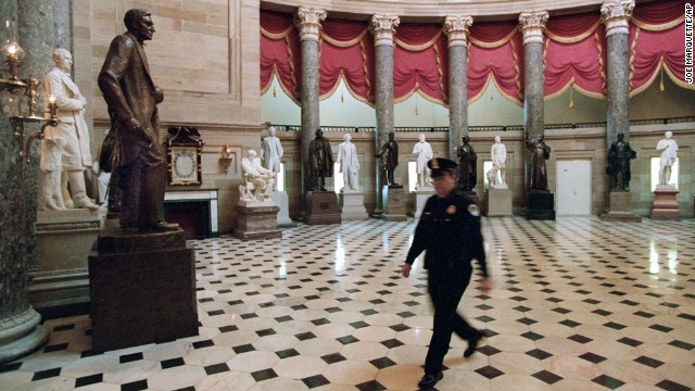 A police officer walks through the empty Statuary Hall in the Capitol on November 15, 1995.