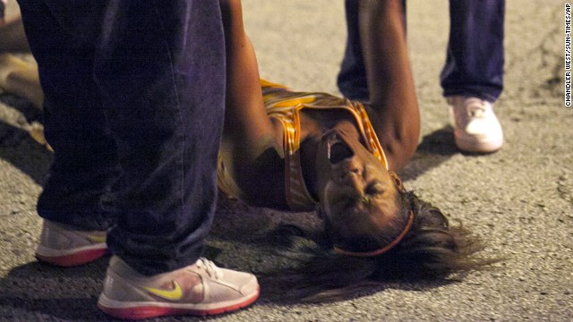 A woman is overcome with emotion near the scene of the shooting at Cornell Square Park in Chicago's Back of the Yard neighborhood on September 19.