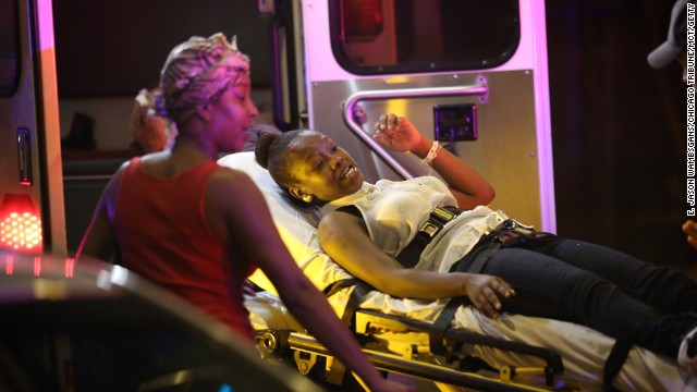 Emergency personnel transport victims from the scene of the shooting on September 19.