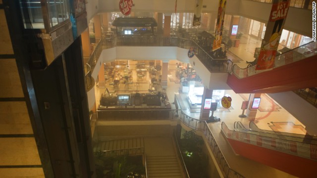 A body is seen on the floor inside the smoke-filled four-story mall.