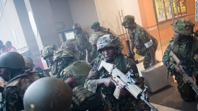 Armed police leave after entering the mall. At least one suspect has been killed, a government official said. Police have said another suspected gunman has been detained at a Nairobi hospital.