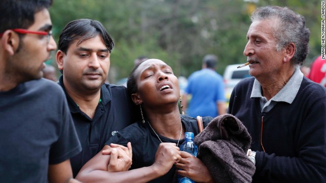 A woman reacts after she is rescued from the mall. 