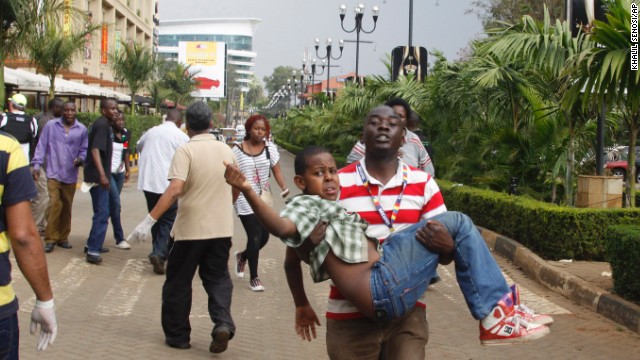 A rescue worker helps a child outside the mall on September 21.