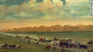 Painting by W.H. Jackson shows pioneers crossing the plains with the Sand Hills of Nebraska\'s Platte Valley in the background. 