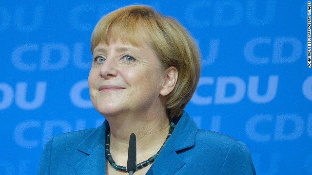 German Chancellor Angela Merkel smiles at supporters after the first exit polls were released on September 22, 2013.