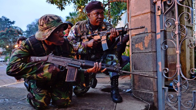 Soldiers take cover after gunfire near the mall on September 23.