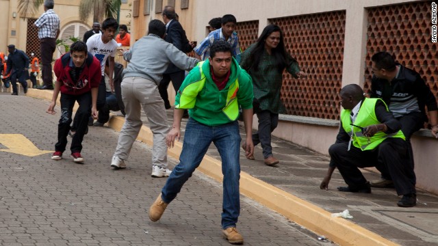 People run for cover outside the mall after heavy shooting started on September 23.