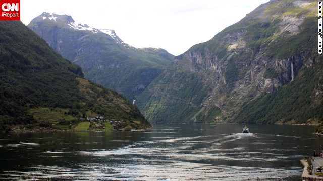 A boat travels along a fjord in Geiranger. "It is difficult to imagine that a more pristine, gorgeous land exists than <a href='http://ireport.cnn.com/docs/DOC-940021'>what we saw in Norway</a>," said Michael Gannon.