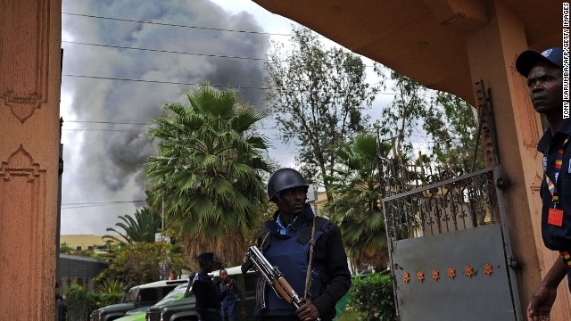 A Kenyan police officer guards the entrance of a building near the mall on September 23.