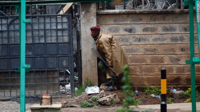 A Kenyan security officer takes cover as gunfire and explosions are heard from the mall on September 23.