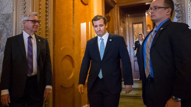 Cruz emerges from the Senate Chamber on September 25 after spending more than 21 hours railing against Obamacare.