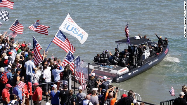 Oracle Team USA was given a huge ovation by the home crowd as its team members boarded the ferry. Supporters flocked to watch with the prospect of history being made.