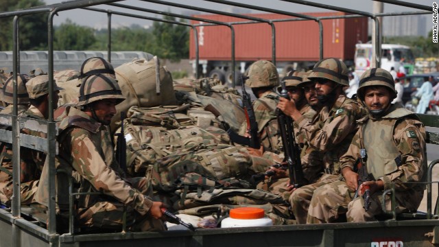 Members of Pakistan's army prepare to travel to Balochistan province from Karachi on September 25.