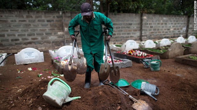 A cemetery worker gathers his tools after a funeral on September 25.