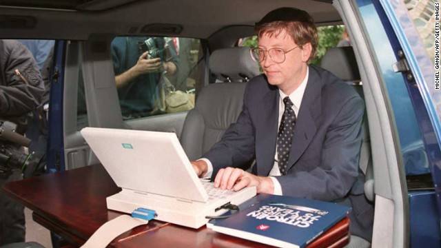 Microsoft president Bill Gates demonstrates Microsoft's Windows 95 program from his automobile prior to a press conference in Paris in September 1994.