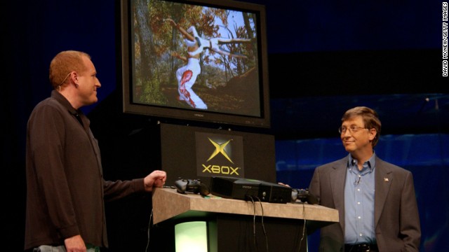 Gates watches Microsoft's Seamus Blackley present a game under development for Microsoft's Xbox in 2001 at the Comdex computer show.
