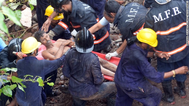 Rescuers pull a man from the rubble while the search continues for survivors.