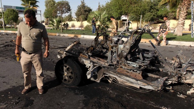 A member of the Iraqi Kurdish security forces inspects the site of a car bomb explosion in Arbil, on September 29, 2013.