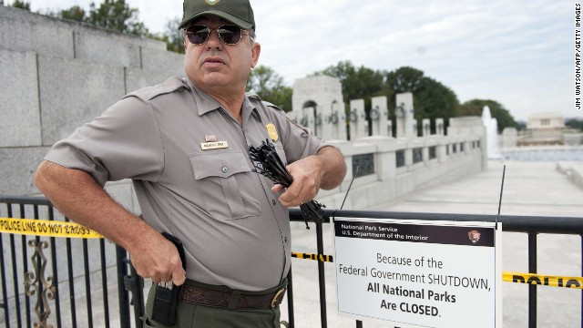 A U.S. park ranger places a closed sign on a barricade in front of the World War II Memorial in Washington on October 1.