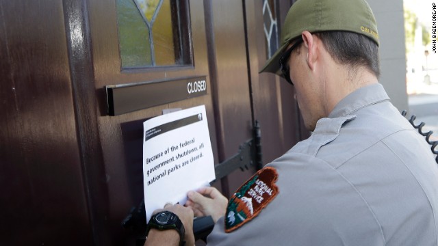 A National Parks Service ranger posts a sign on the doors of the historic Ebenezer Baptist Church in Atlanta on October 1 notifying visitors that the church is closed.