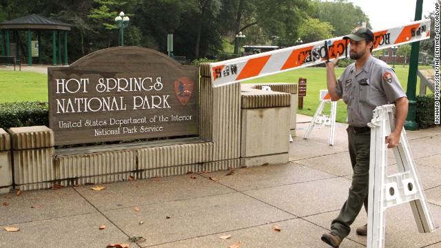 Hot Springs National Park employee Stacy Jackson carries a barricade while closing Arlington Lawn in Hot Springs National Park in Arkansas on October 1.