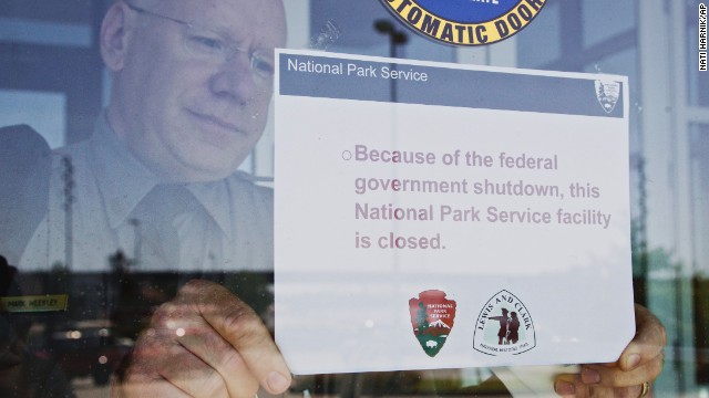 Mark Weekley, superintendent at the National Park Service's Lewis and Clark National Historical Trail, puts up a sign proclaiming the facility closed due to the federal government shutdown, in Omaha, Nebraska, on October 1.