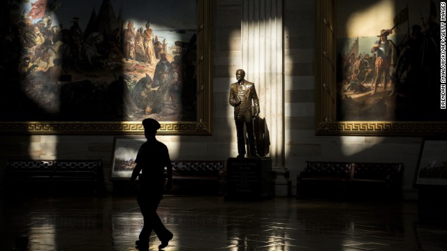 A U.S. Capitol police officer walks past a statue of Gerald Ford in the rotunda on Tuesday, October 1. The Capitol is closed to tours because of the government shutdown.