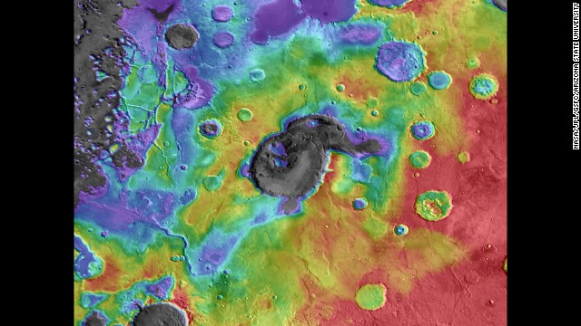 Scientists believe this caldera, Eden Patera, on Mars is an ancient supervolcano. In this image of the caldera, digital-elevation data is overlaid on daytime thermal infrared images. (Red means higher elevations, while purple/gray means lower.) The crater in the middle is about 70 kilometers wide and 1,800 meters deep.