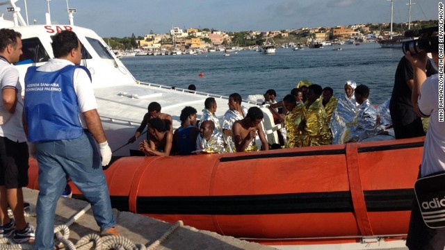 An Italian Coast Guard boat carries rescued migrants into the port of Lampedusa on Thursday, October 3. According to the nation's coast guard, a boat carrying as many as 500 people capsized and caught fire off the Italian island of Lampedusa.