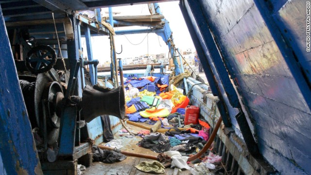 Migrants' belongings are scattered across the deck of a ship on October 3. 