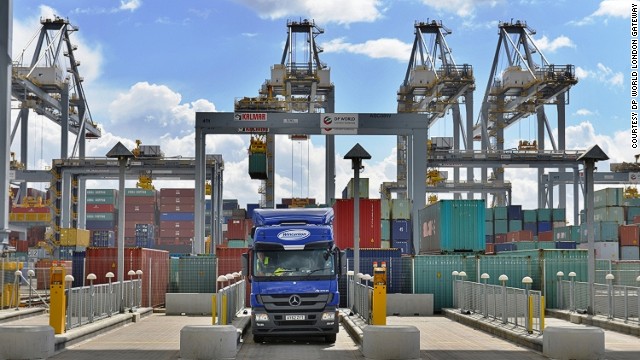 A lorry waits in a loading bay at London Gateway while a ship is unloaded in the background.