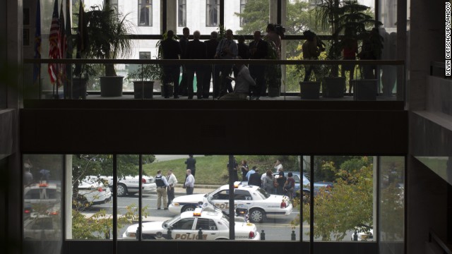 Members of the media watch as Capitol Hill Police respond to the report of shots fired. 