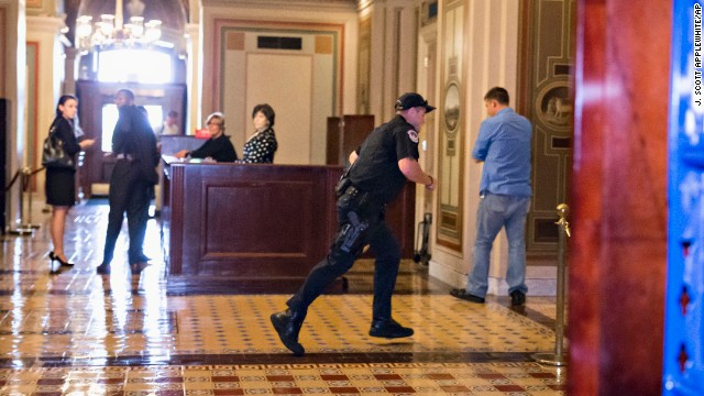 A Capitol Police officer runs through the first-floor lobby in the Senate wing on Capitol Hill.