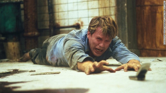 For almost the entire running time of <strong>"Saw"</strong> (2004), a corpse lies in a pool of blood on the floor of well-hidden washroom. Meanwhile, two chained figures, played by Cary Elwes and Leigh Whannell, realize they're part of a brutal serial killer's game. After much gore and misdirection, the serial killer is revealed to be the corpse -- who's not so dead after all.