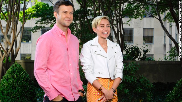 Taran Killam and Cyrus pose in a promo for her upcoming "Saturday Night Live" episode on October 5.