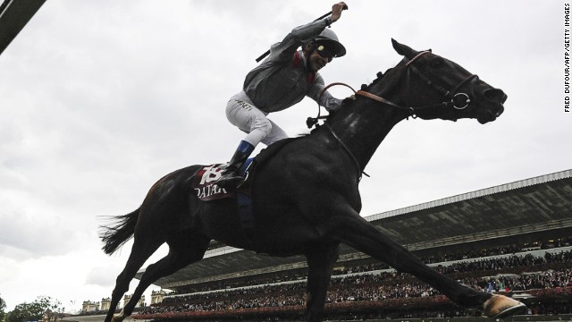 Jockey Thierry Jarnet celebrates after filly Treve romps to victory at the Prix de l'Arc de Triomphe at Longchamp.