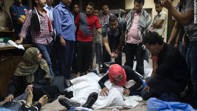 People mourn over the bodies of lost relatives on October 6 in Cairo.