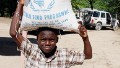 A Haitian child carries a bag of food during a food distribution from the United Nations World Food Program, Programme Alimentaire Mondial (PAM) on November 12, 2009 in Balan a suburb of Ganthier. 