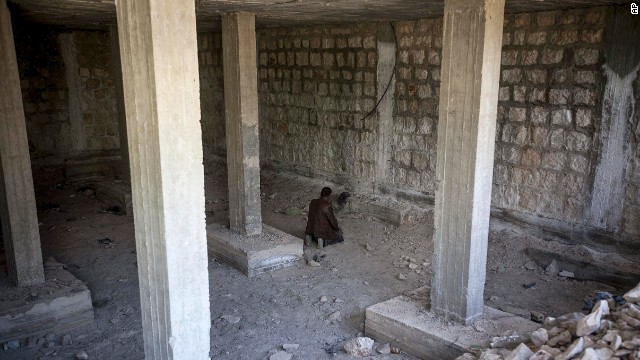 A rebel fighter prays moments before heading into battle in Maaret al-Numan, Syria, on Monday, October 7.